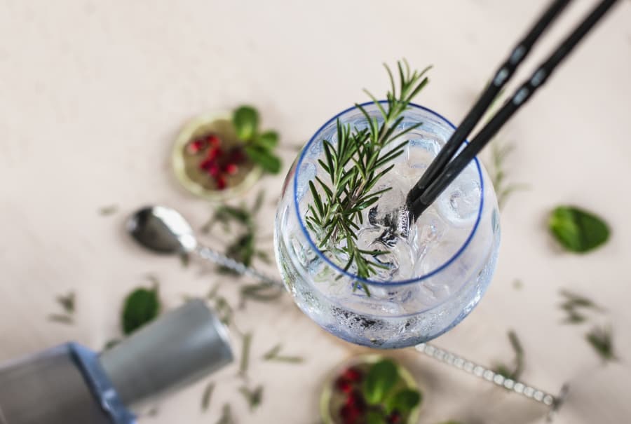 A gin and soda with rosemary