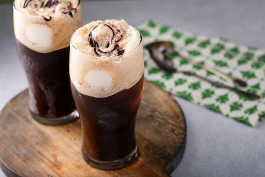 Dark stout beer ice cream float in glass with chocolate syrup drizzle