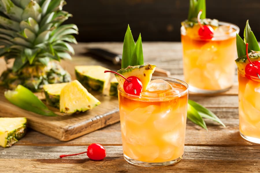 Rum Runner cocktail in a glass with pineapple and cherry